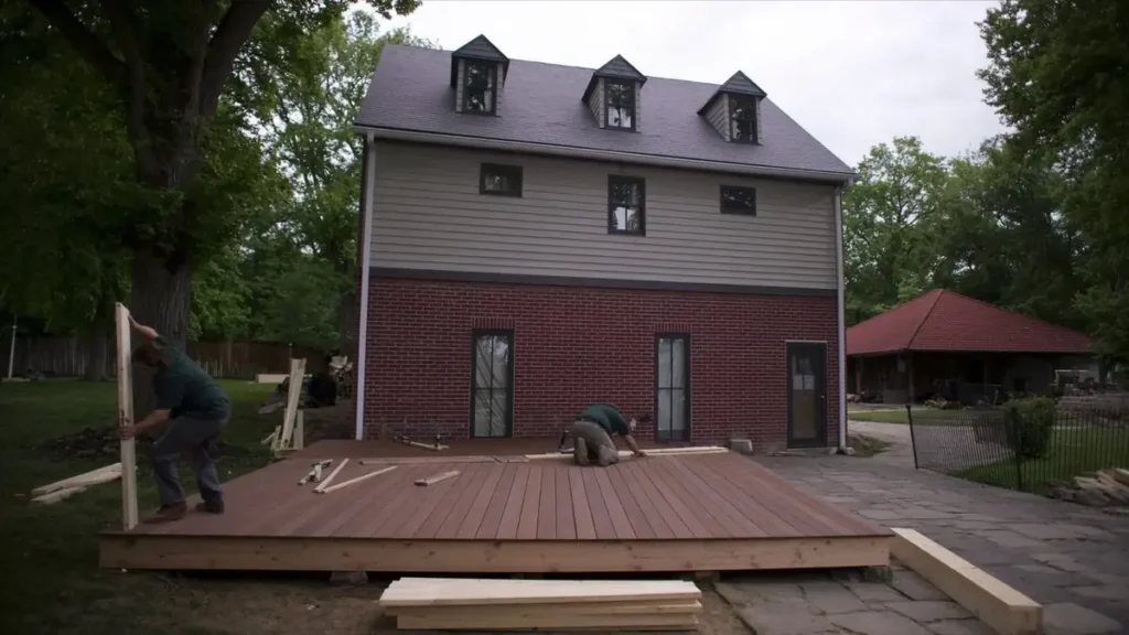 Deck being built onto the rear of a house