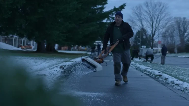 Salting a cleared walkway at first light in winter