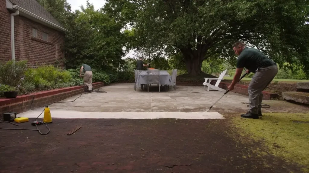 Pressure washing a patio, cleaned surface against the dirty section